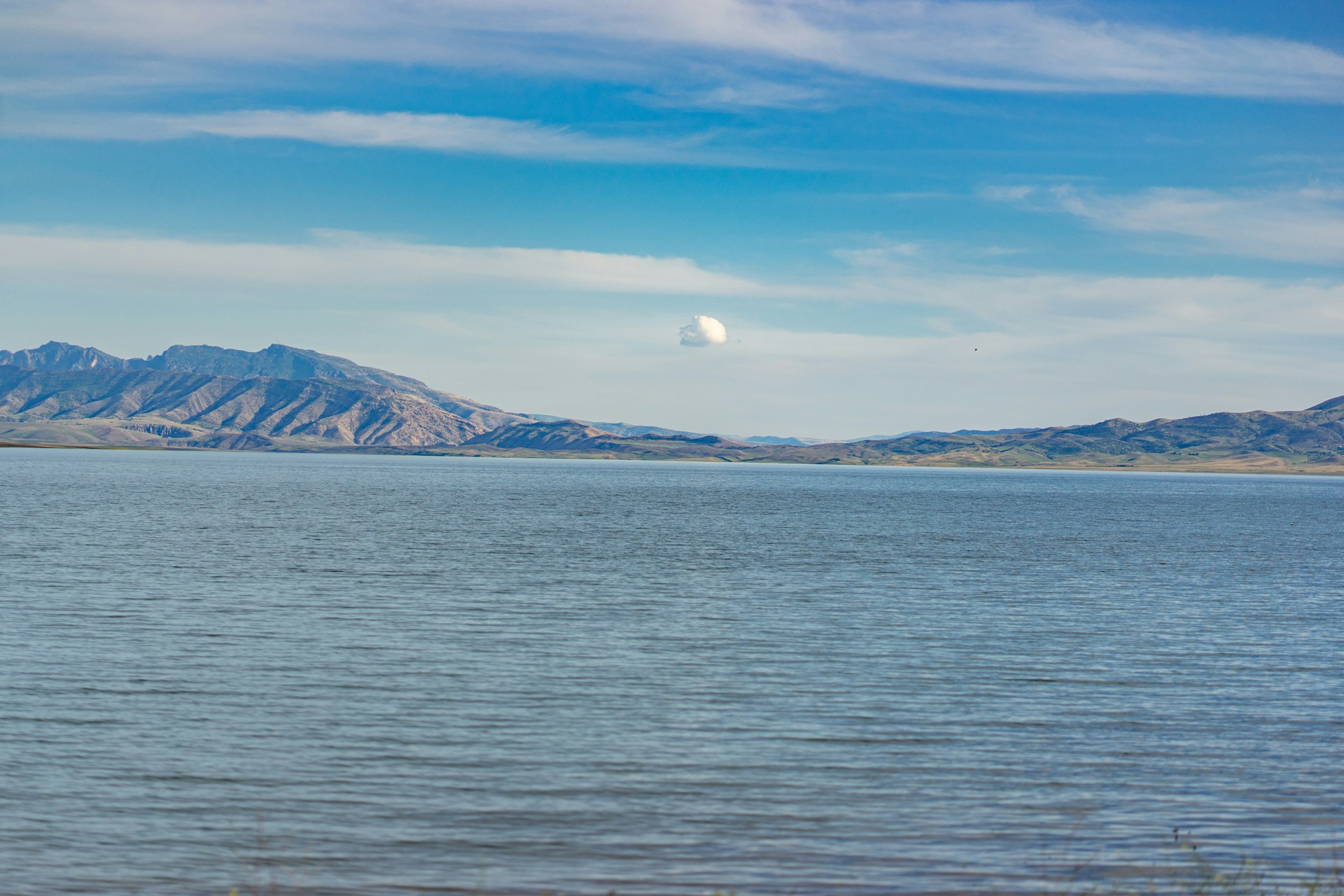 a large body of water with mountains in the background