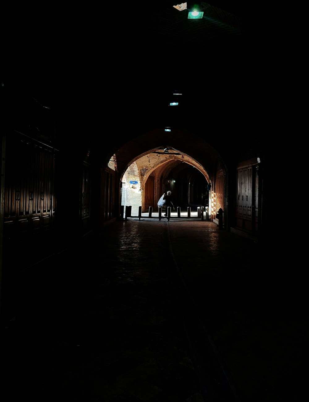 a dark tunnel with a person standing in it