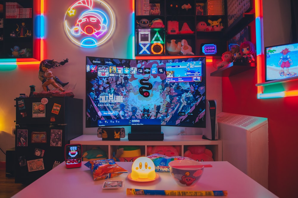 a living room with a large television and neon lights