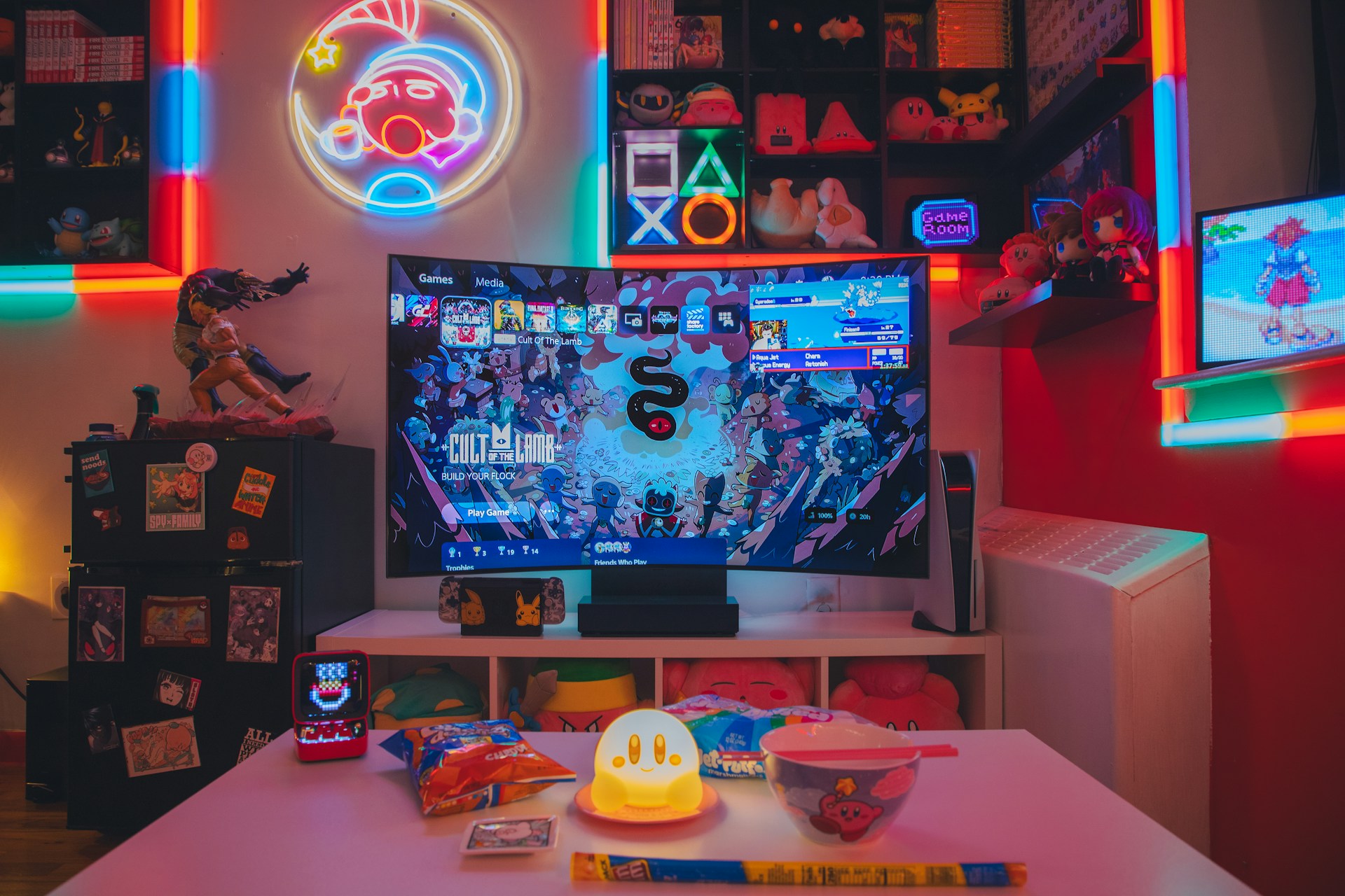 a living room with a large television and neon lights
