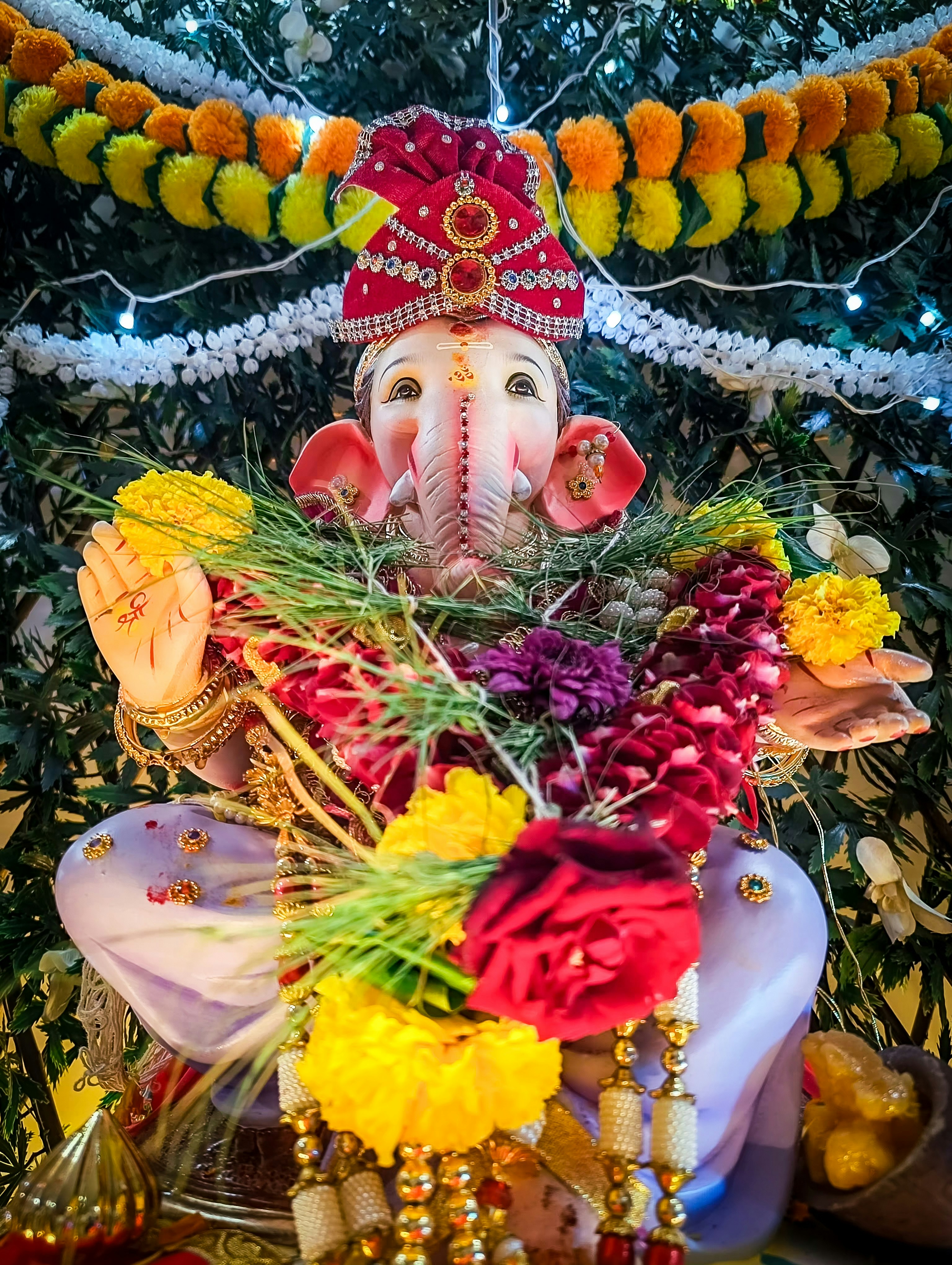 Ganesh Puja ceremony with decorated idol and flowers
