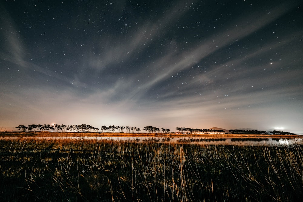 the night sky is filled with stars and clouds