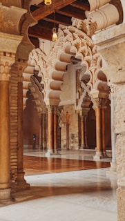 a large room with columns and a clock on the wall