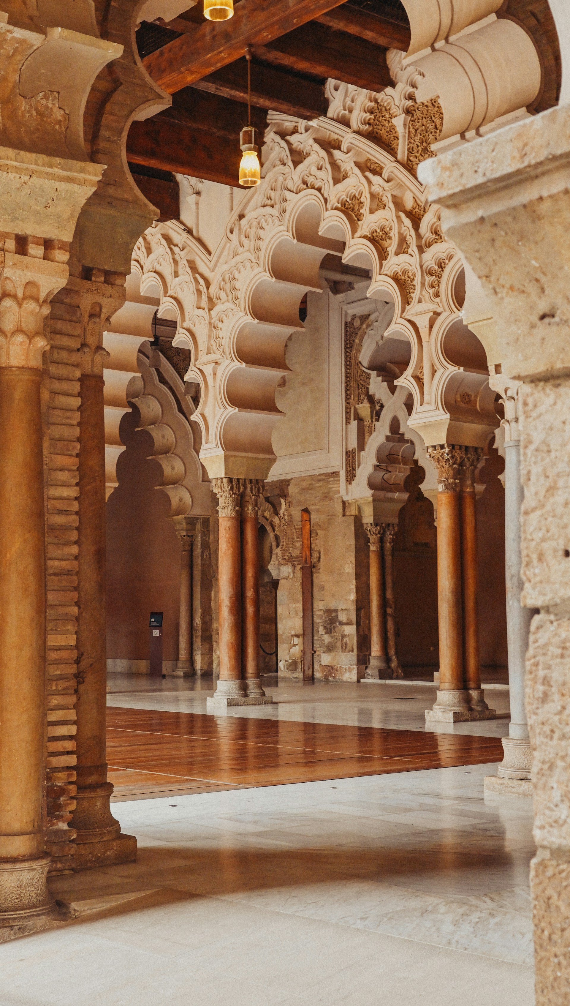 a large room with columns and a clock on the wall