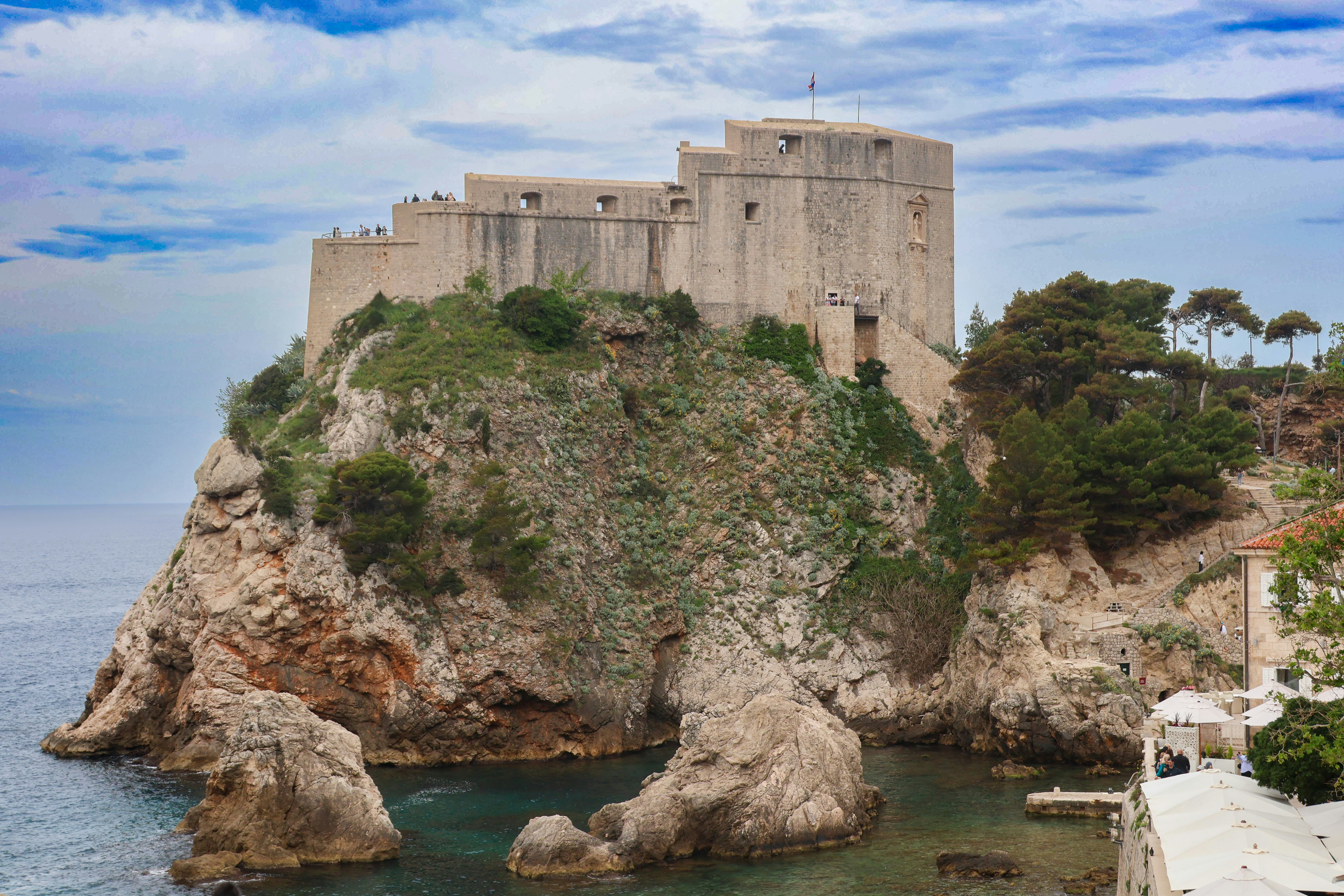 A castle on top of a cliff next to the ocean