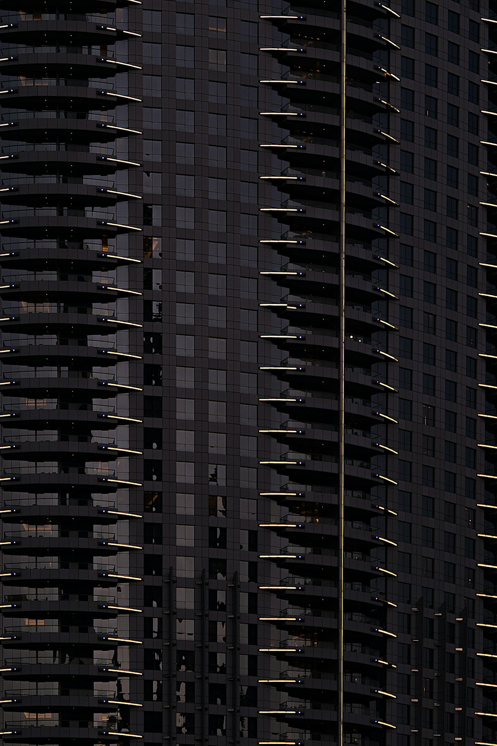 a plane flying in front of a very tall building