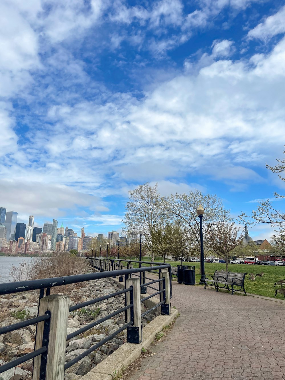 a park with benches and a view of a city