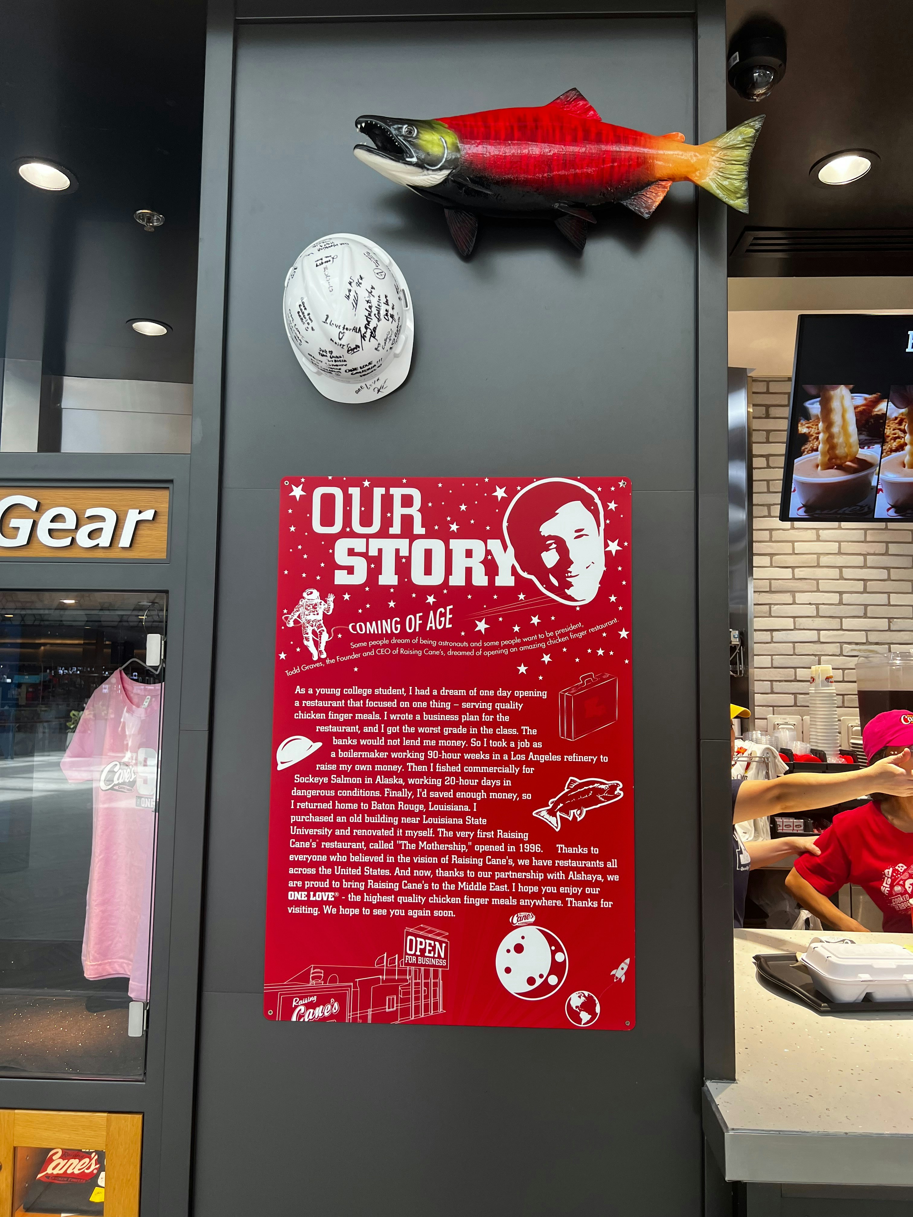 A fish on display in a store next to a sign photo – Free Red Image on ...