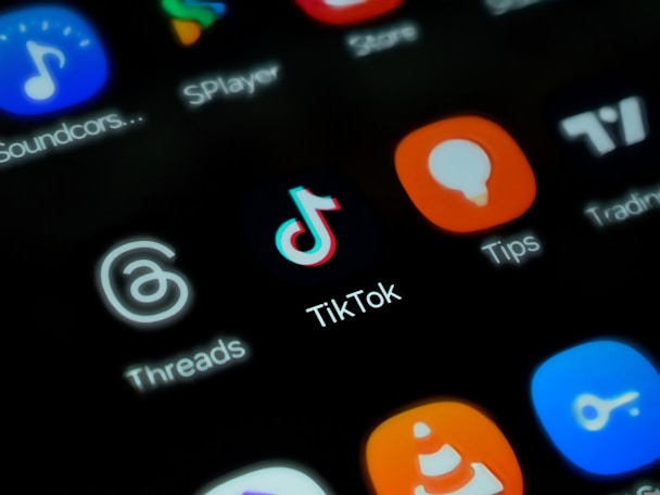 a close up of a cell phone screen with different social media icons
