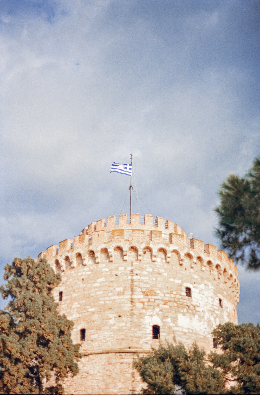 a flag flying on top of a stone tower