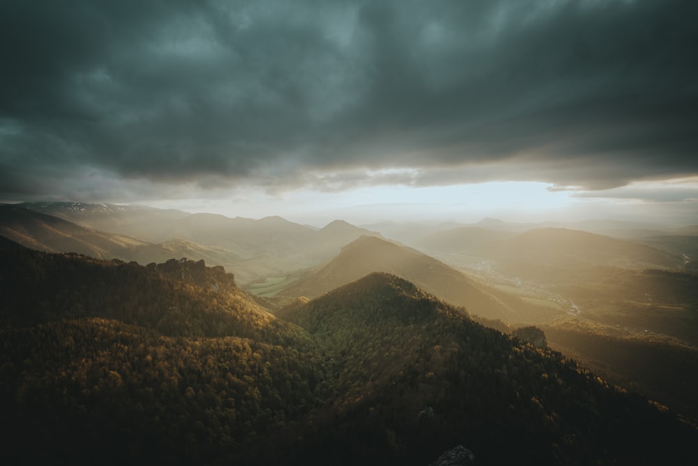 a view of a mountain range under a cloudy sky