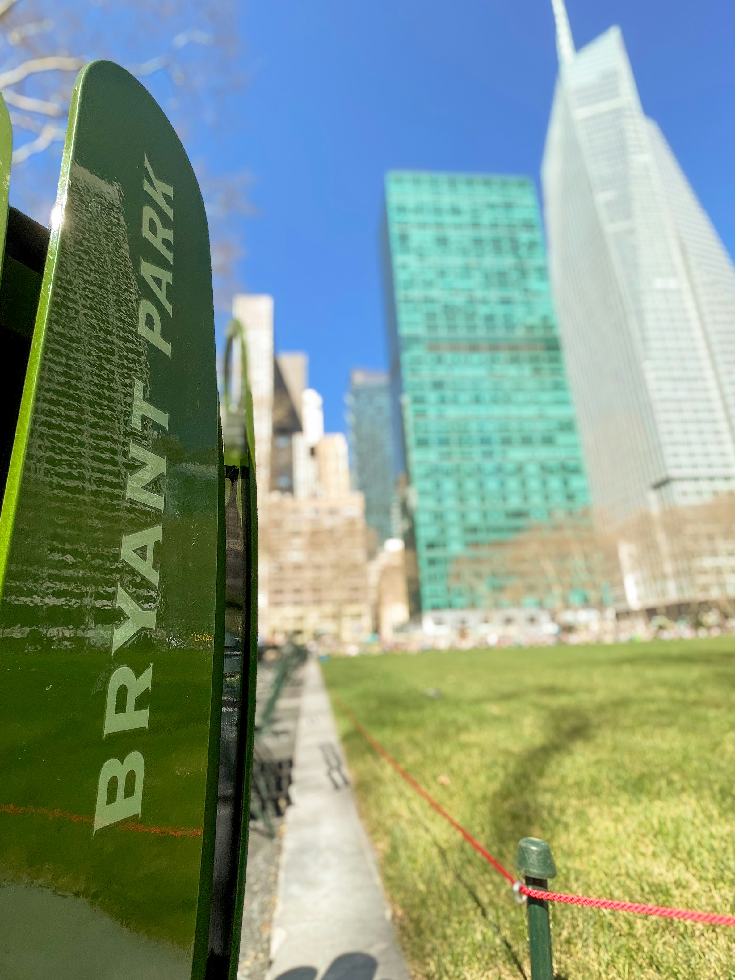 Bryant Park with lush grass and Midtown Manhattan skyscrapers in the background