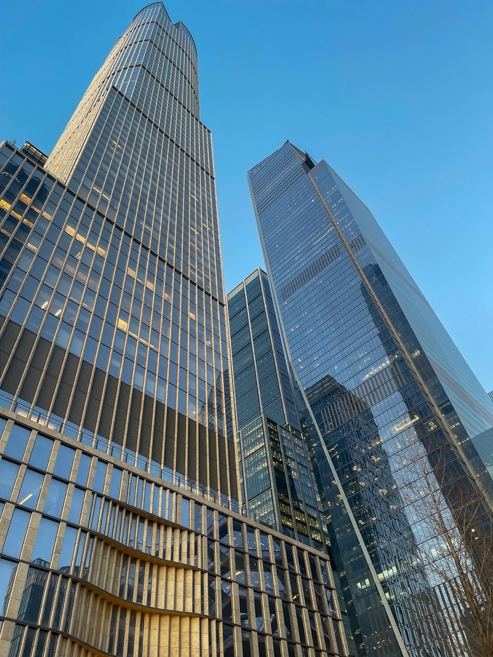 a group of tall buildings with a blue sky in the background