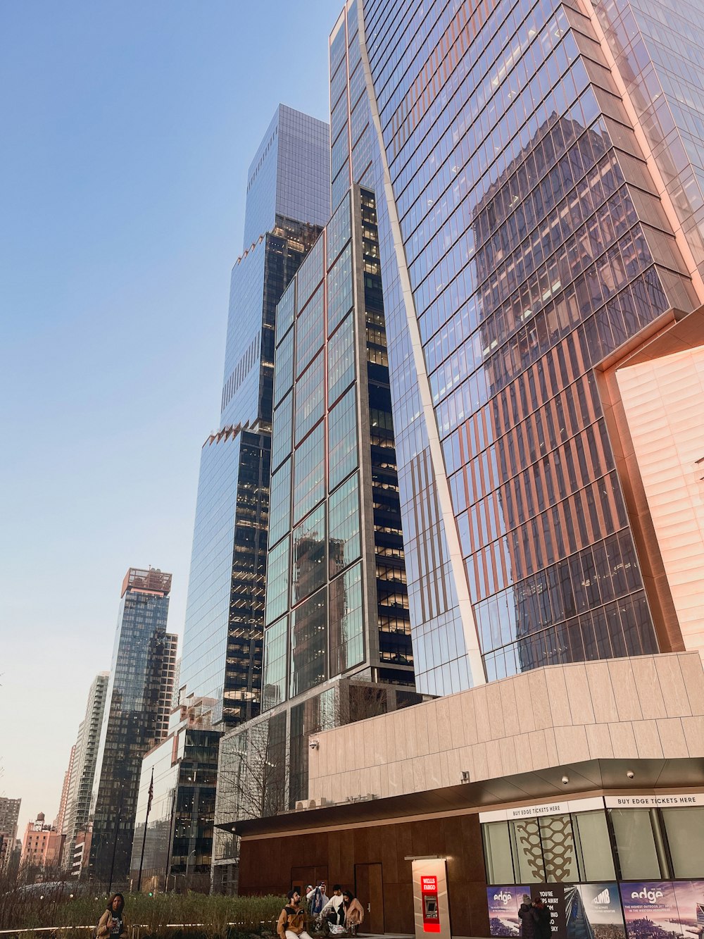 a group of people standing outside of a tall building