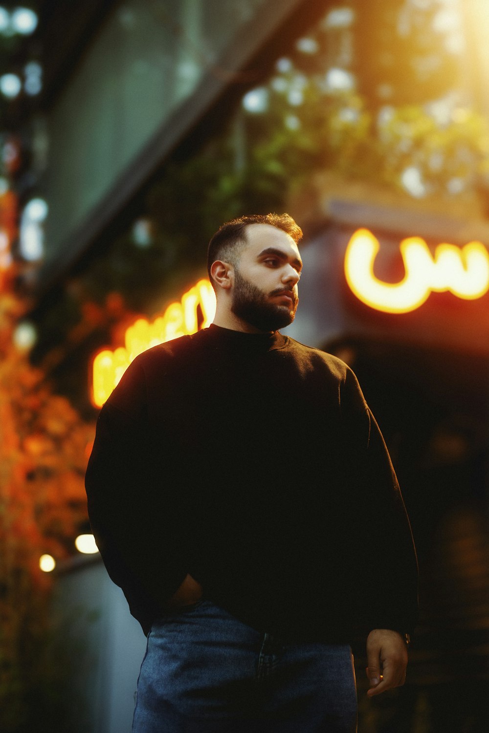 a man with a beard standing in front of a building