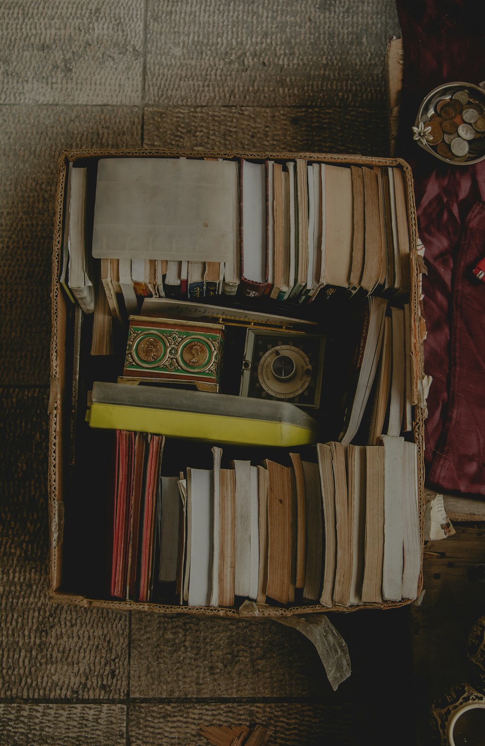 a box filled with lots of books on top of a floor