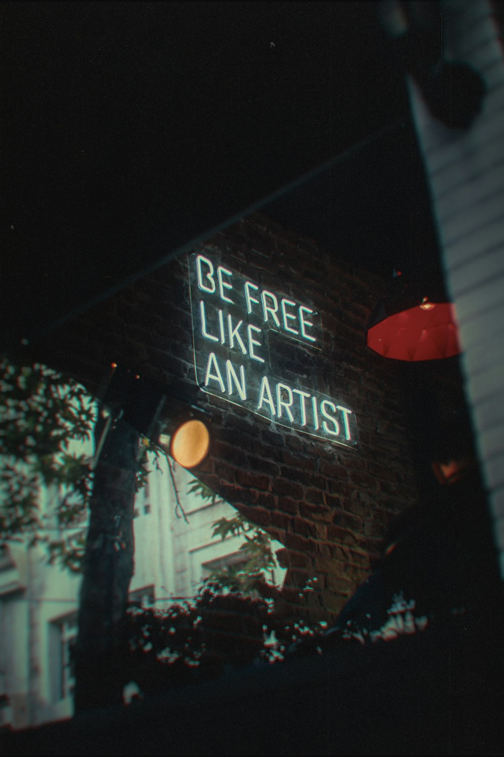 a neon sign that reads be free like an artist