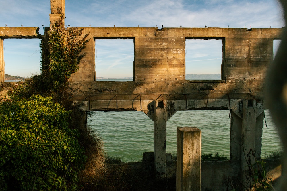 a view of the ocean through a window of an old building