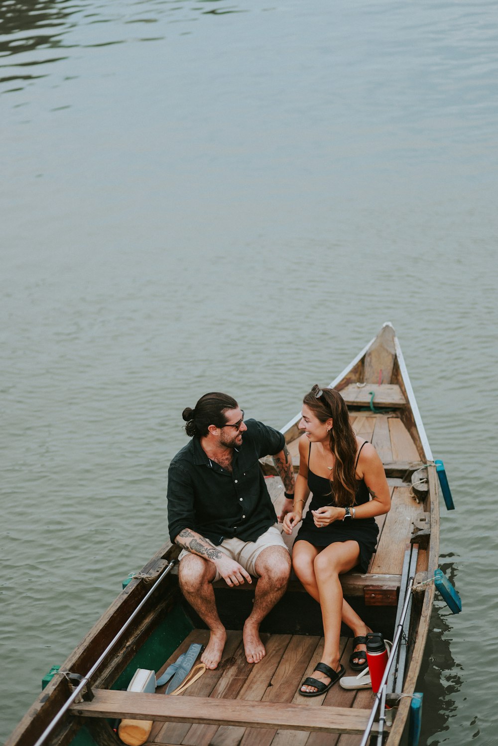 a man and a woman sitting in a boat