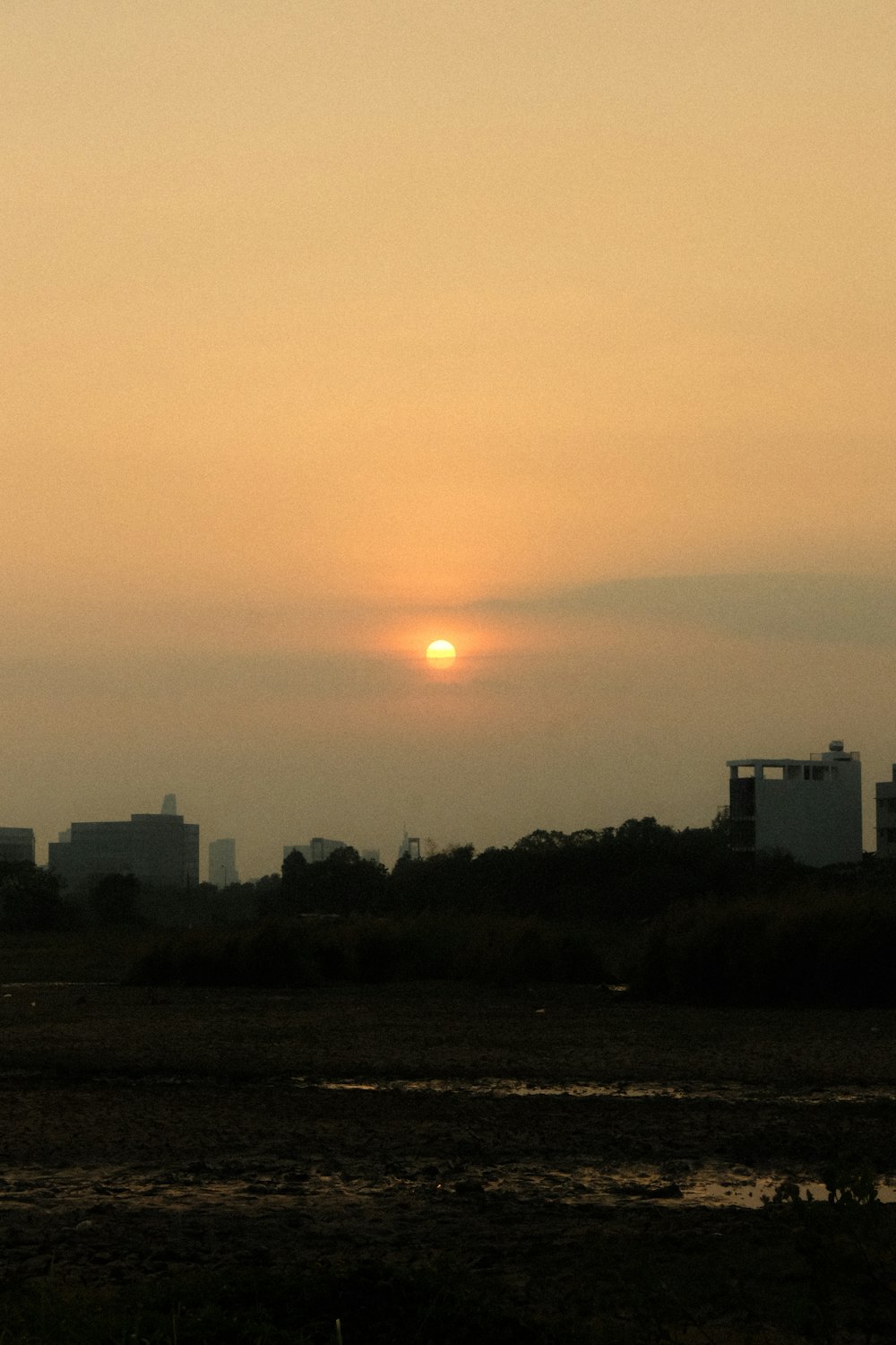 the sun is setting over the city skyline