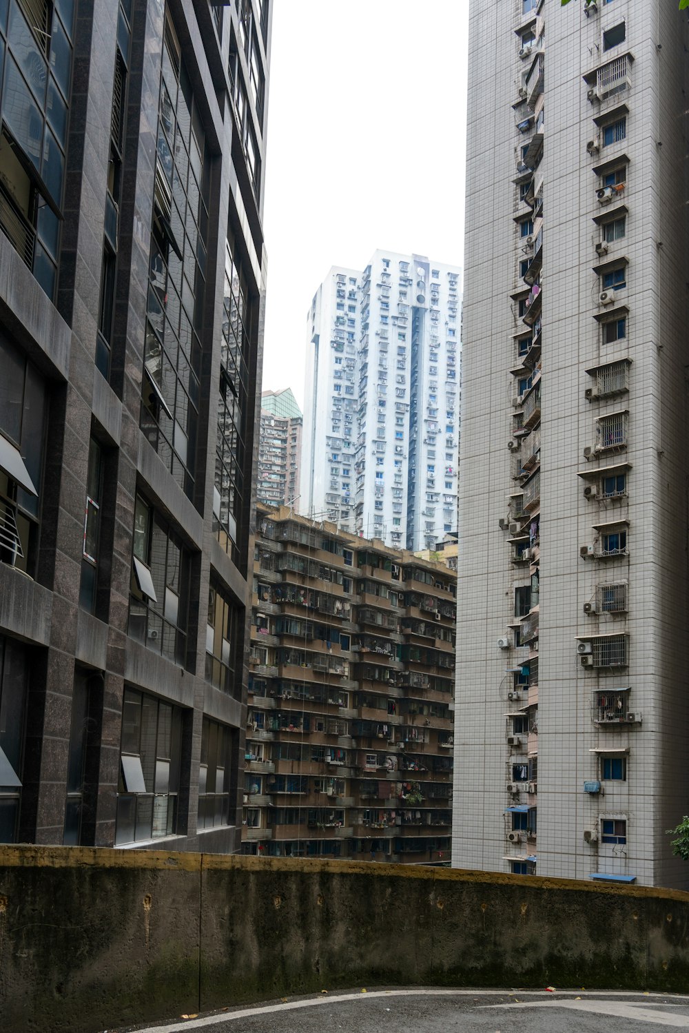 an empty parking lot in a city with tall buildings in the background