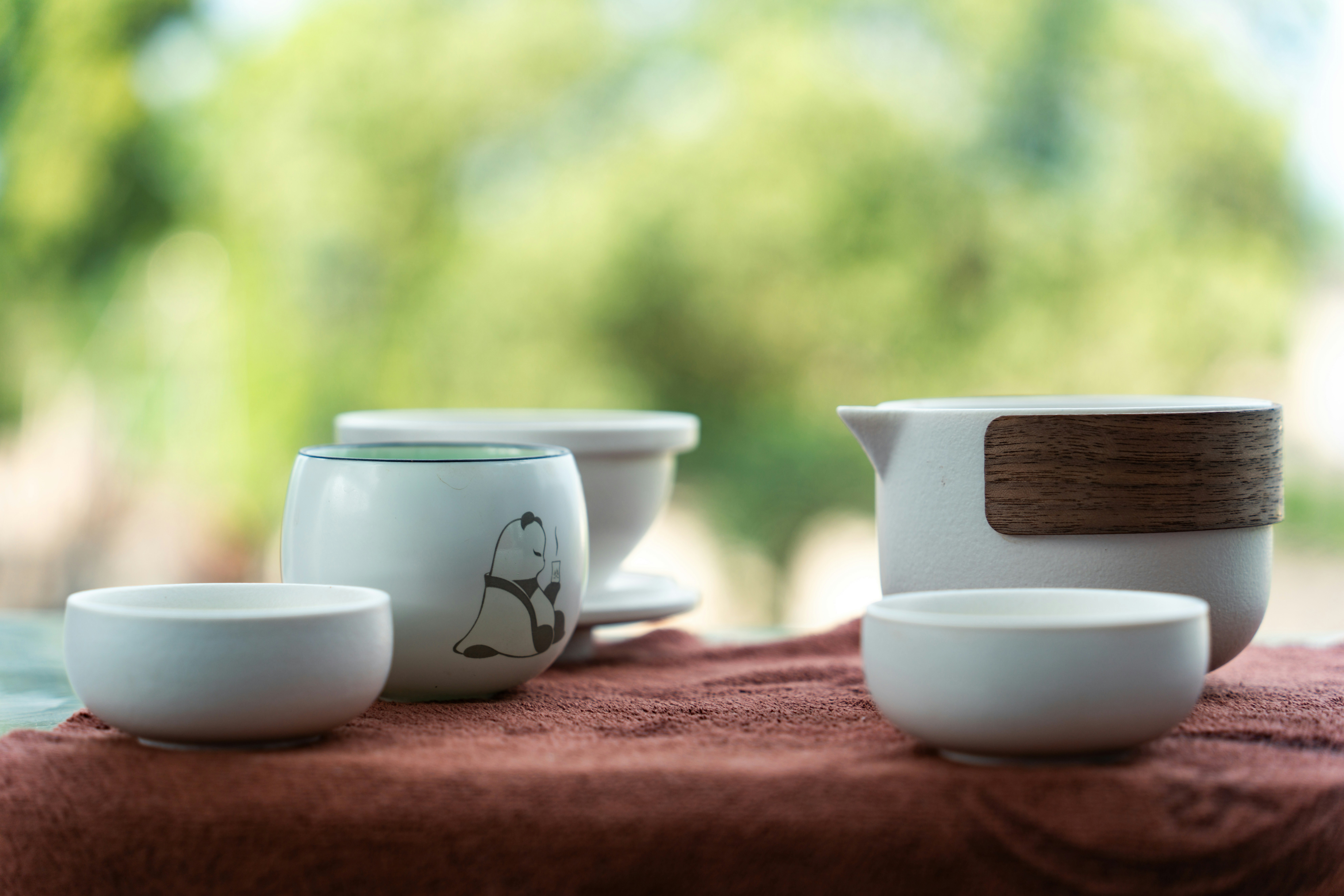 a table topped with white dishes and cups