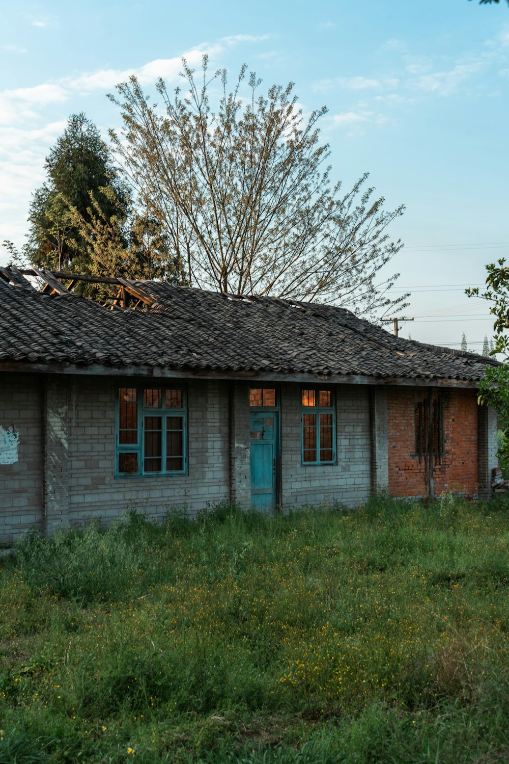 an old run down building with a blue door