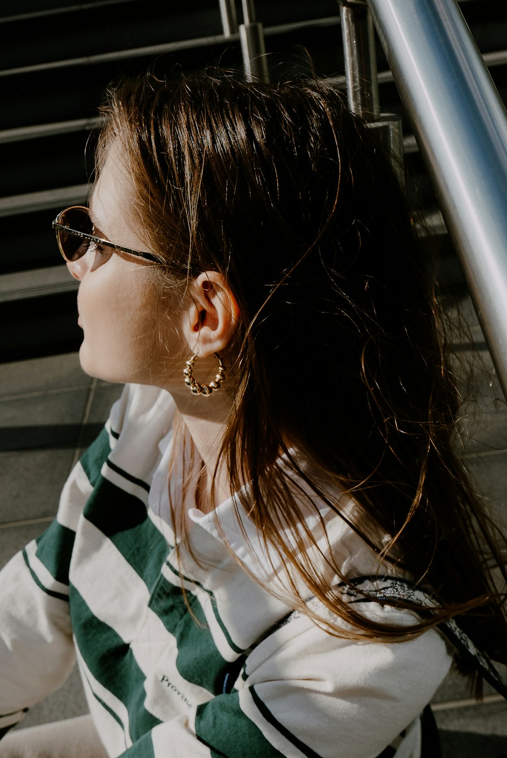 a woman wearing sunglasses and a striped shirt