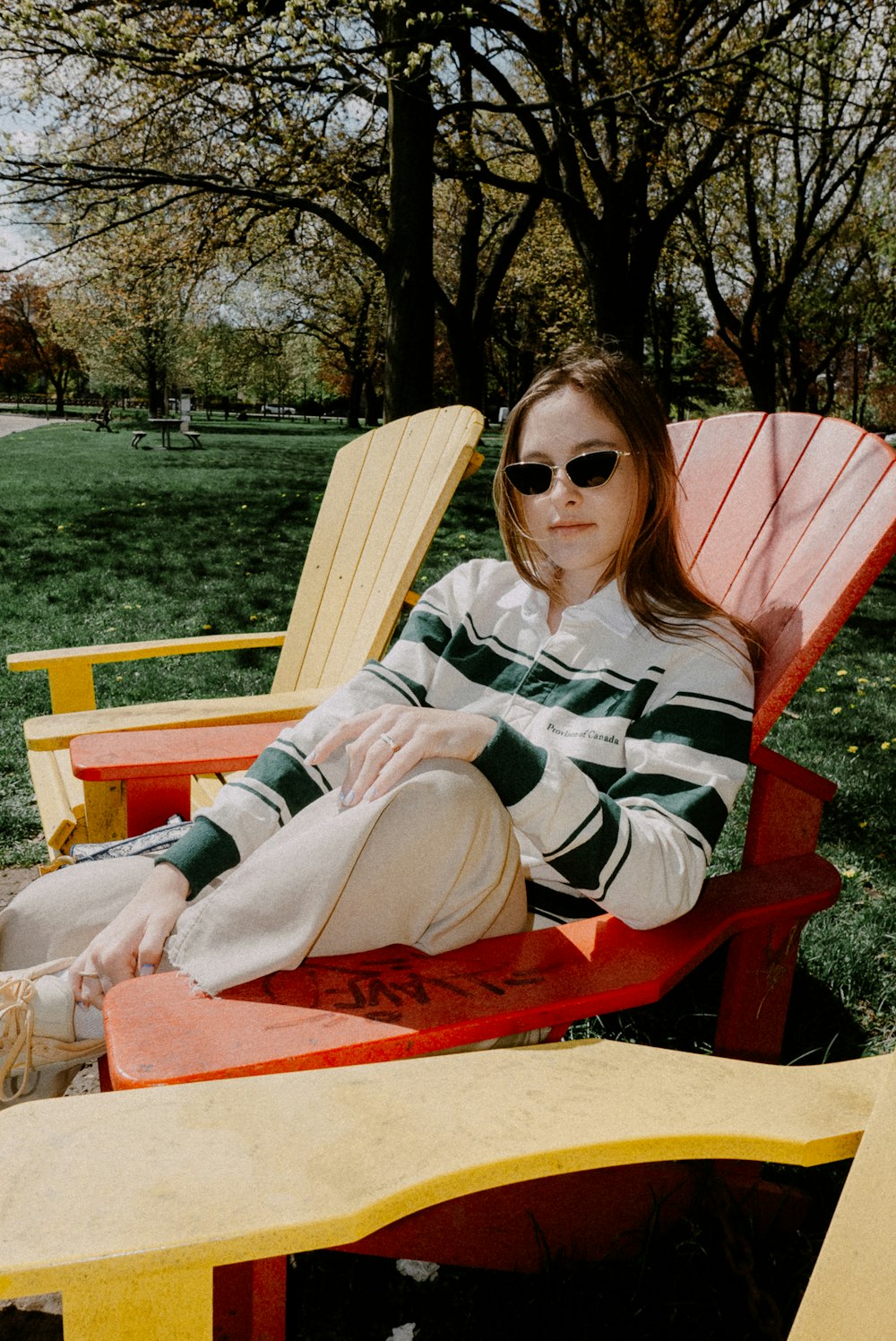 a woman sitting in a red and yellow chair