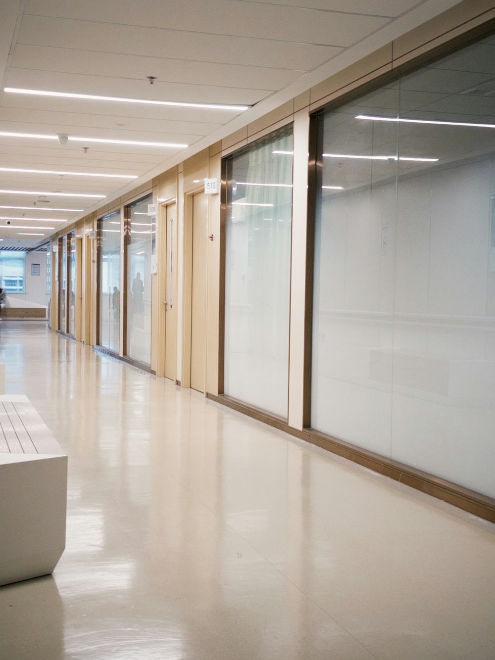 a long hallway with a bench in the middle of it