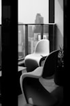 a black and white photo of some chairs and a table