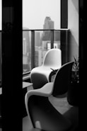 a black and white photo of some chairs and a table