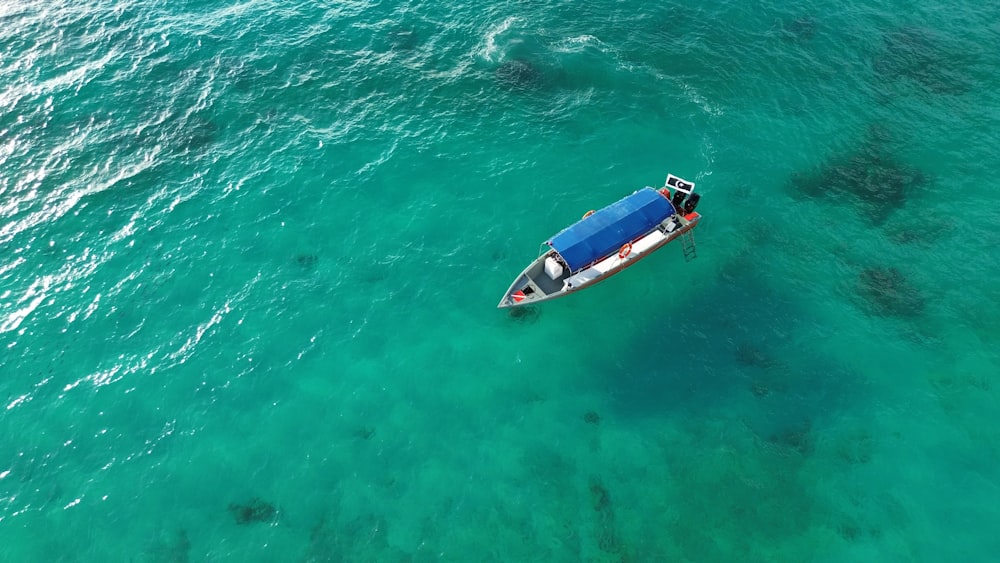 a small boat floating on top of a large body of water