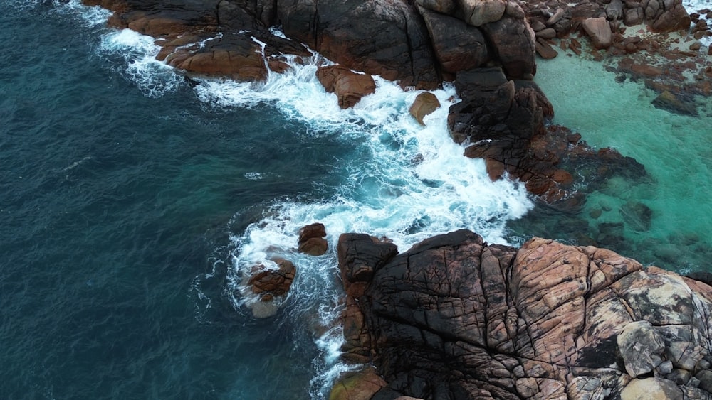 a bird's eye view of the ocean and rocks