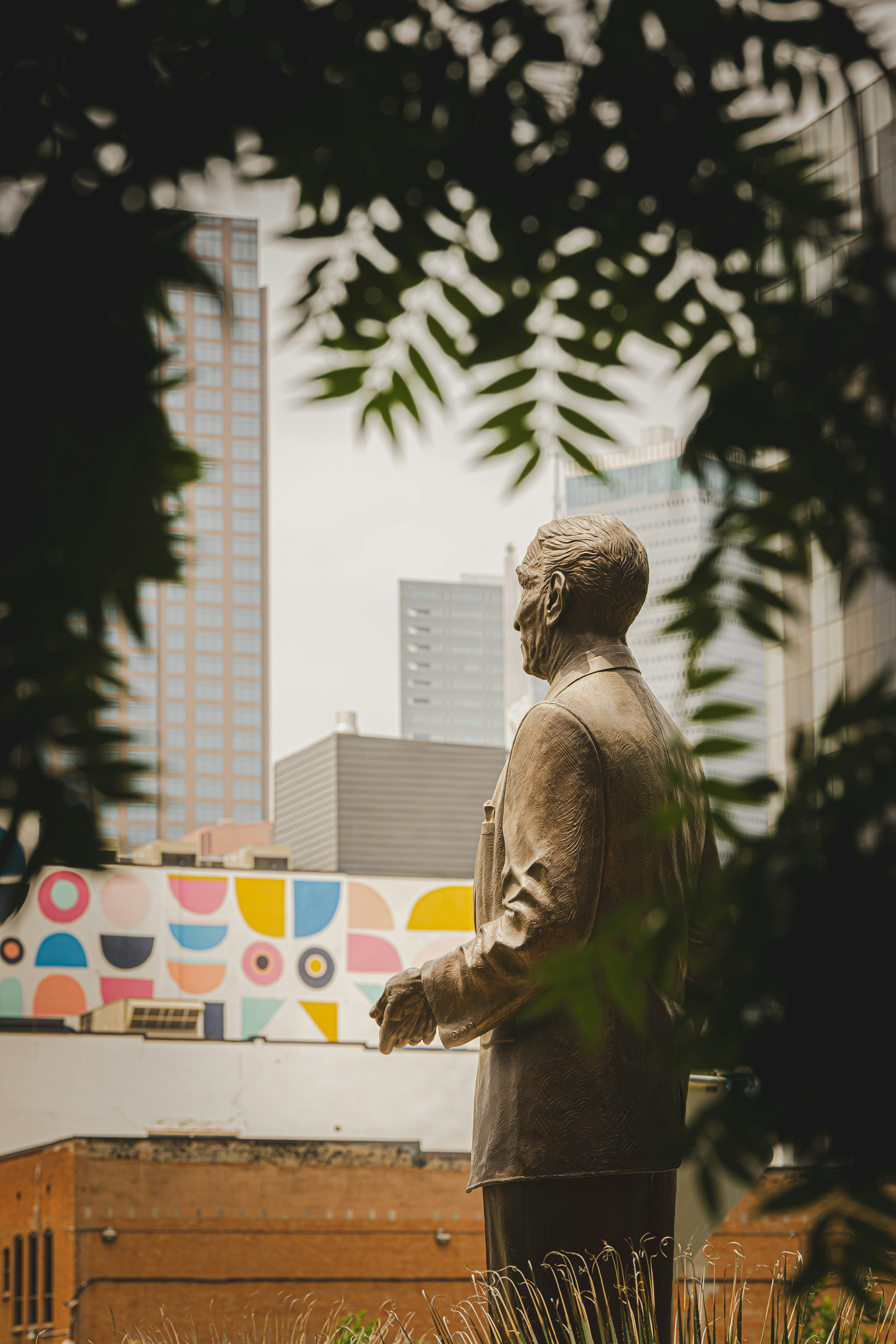 a statue of a man standing in front of a building