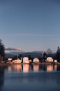a body of water with houses on the shore