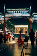 a group of people standing around a train station