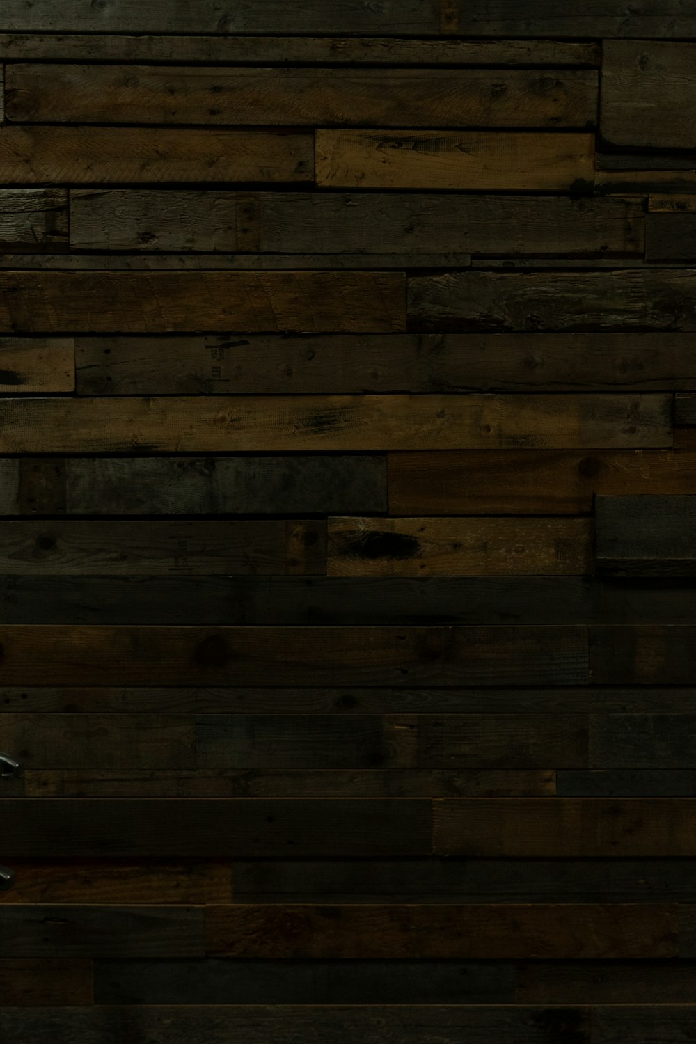 a man in a suit and tie standing in front of a wooden wall