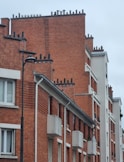 a red brick building with a clock on the side of it