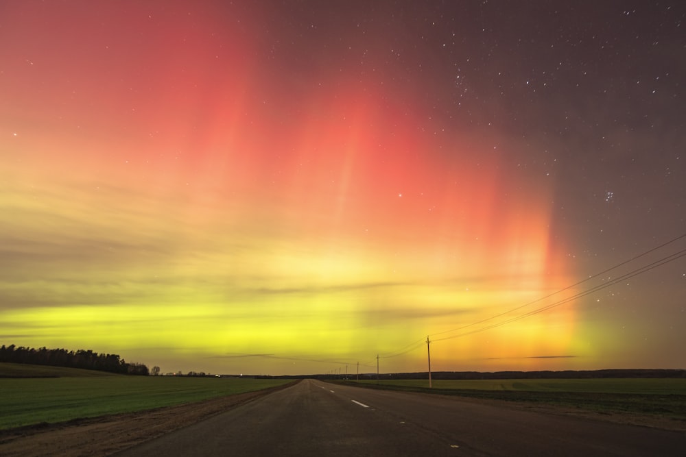 an aurora bore is seen in the sky above a road