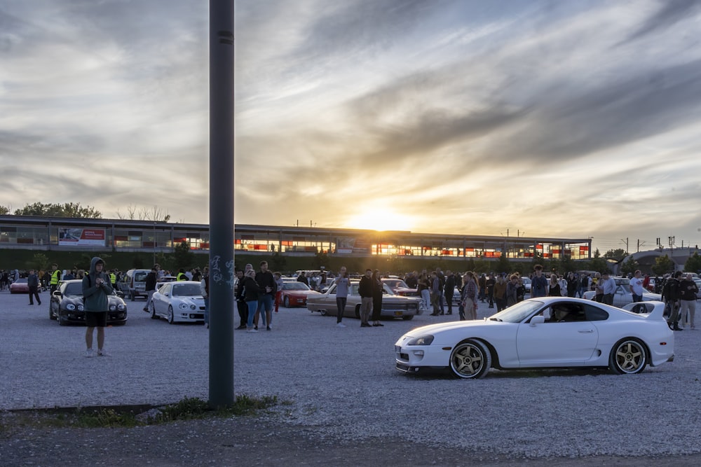 a white sports car parked in a parking lot