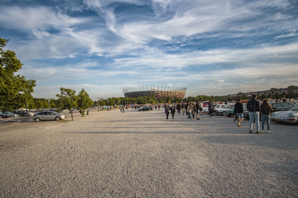 a group of people walking around a parking lot