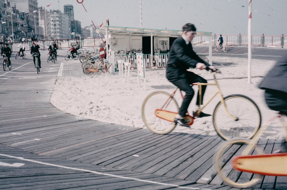 a man riding a bike down a boardwalk