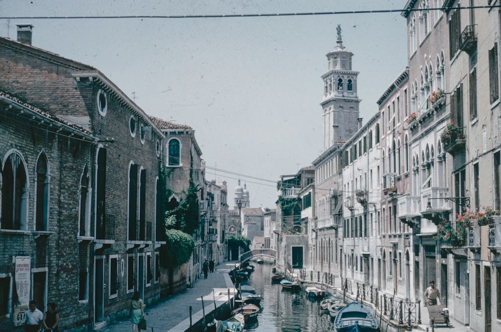 a narrow canal with boats and buildings on both sides