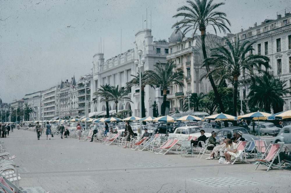 a group of people sitting on lawn chairs in front of a building