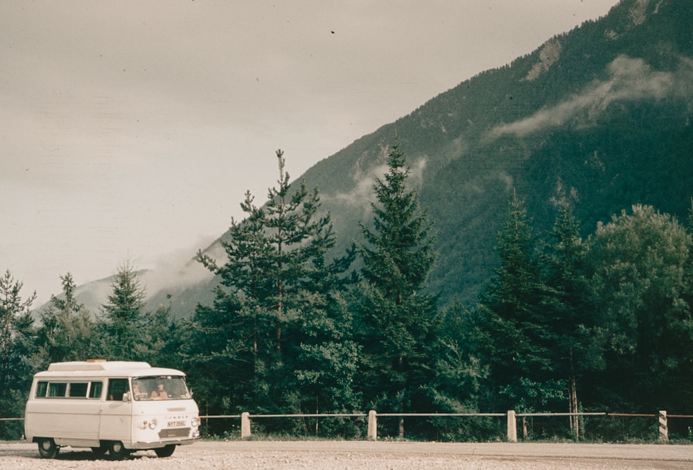 a van is parked in front of a mountain