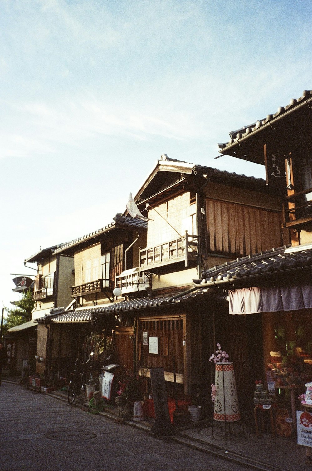 a row of wooden buildings sitting on the side of a road