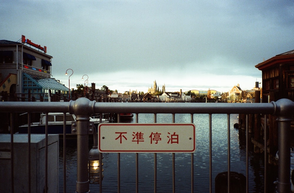 Ein Schild ist an einem Zaun in der Nähe eines Gewässers angebracht
