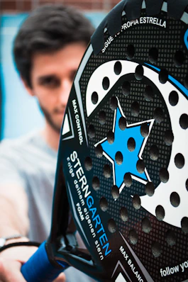 a close up of a person holding a tennis racket