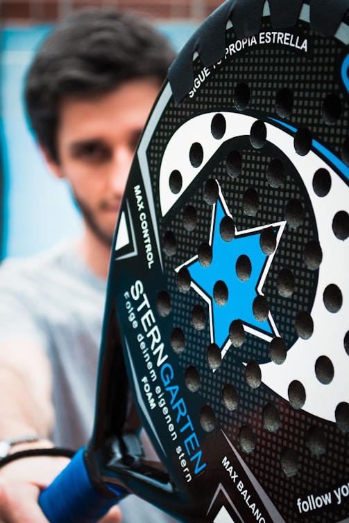 a close up of a person holding a tennis racket